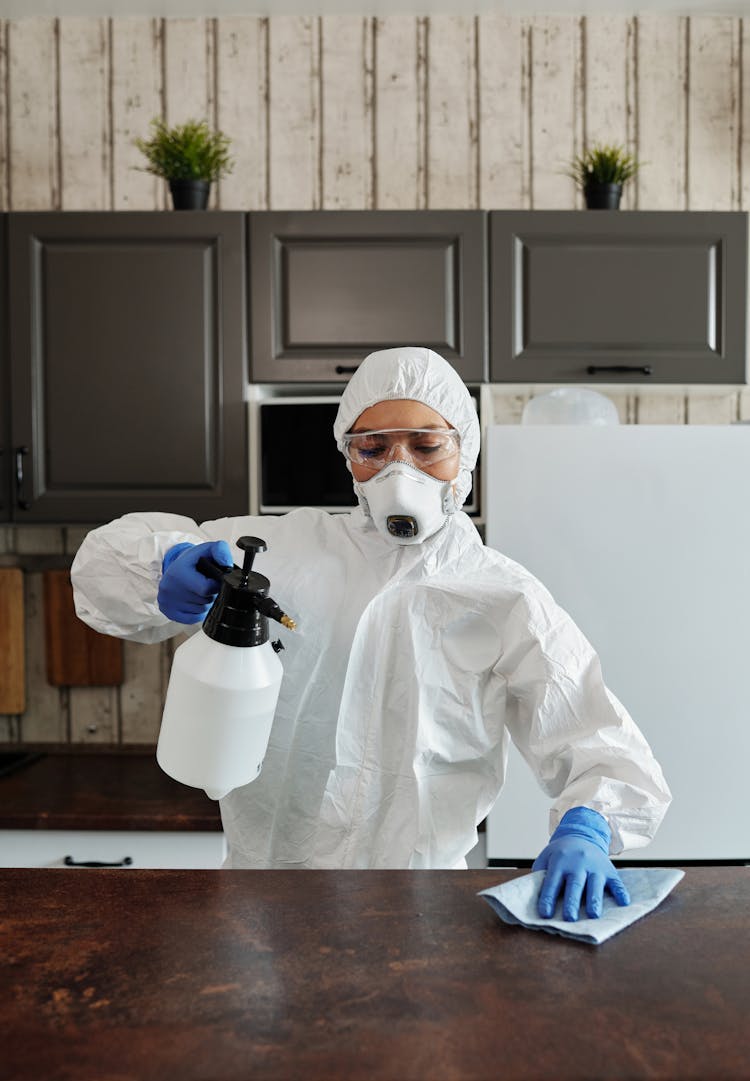 Photo Of Person Disinfecting The Table