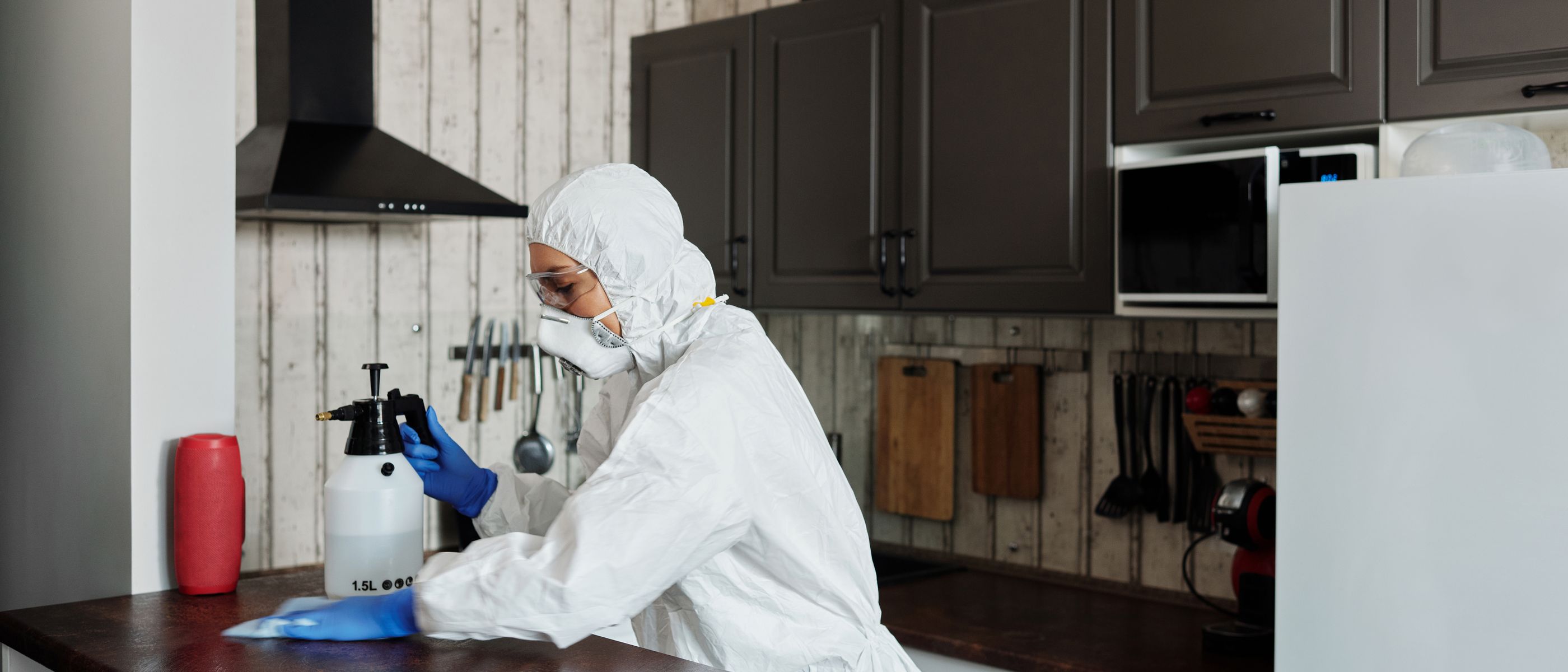 Kitchen Spraying in Surrey Quays — careful masking before painting begins