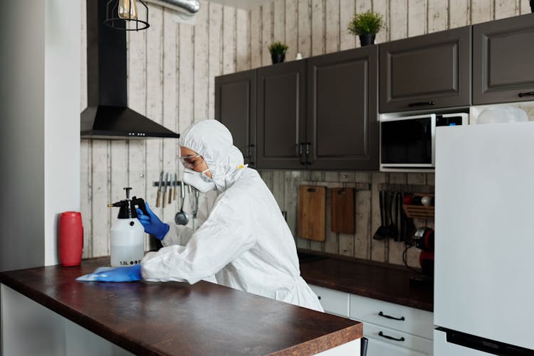 Photo Of Person Disinfecting The Table