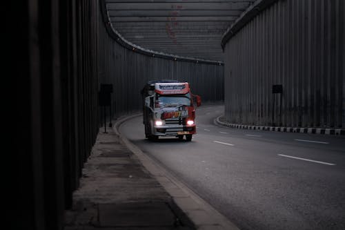 Free Red and Black Truck on Road With Lights On Stock Photo