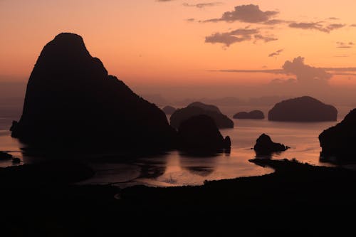 Silhouette of Rock Formations on Water