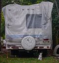 An Abandoned Vehicle Covered With White Plastic