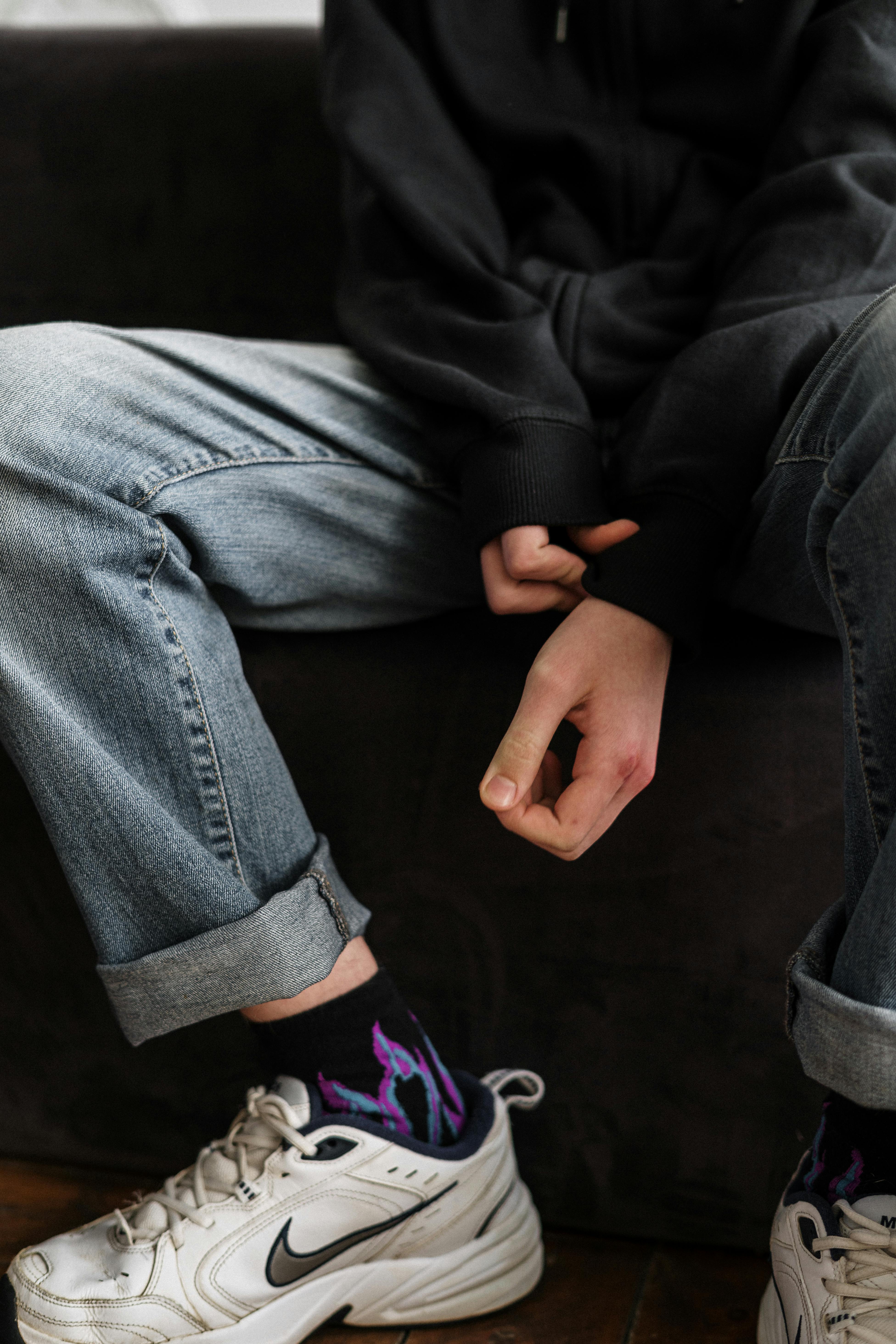 person in black blazer and blue denim jeans