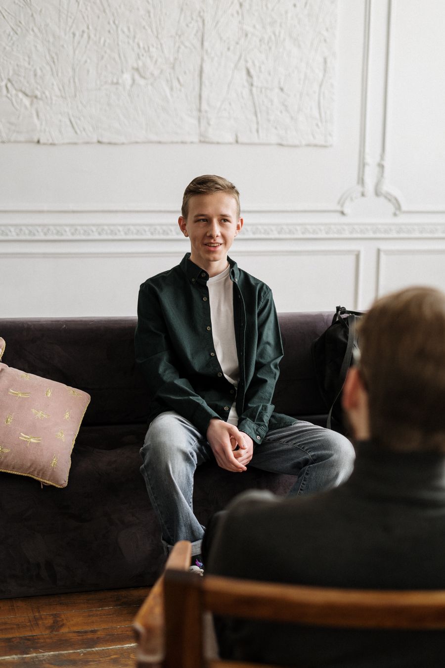 Counselor talking with a client beside a bright office window
