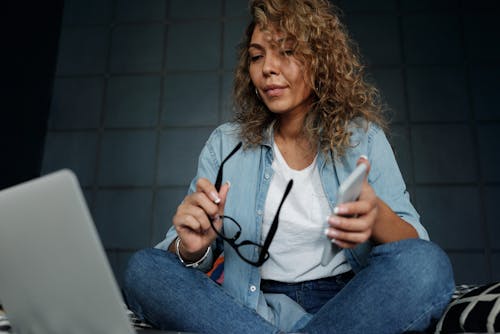 Photo Of Woman Holding Eyeglasses