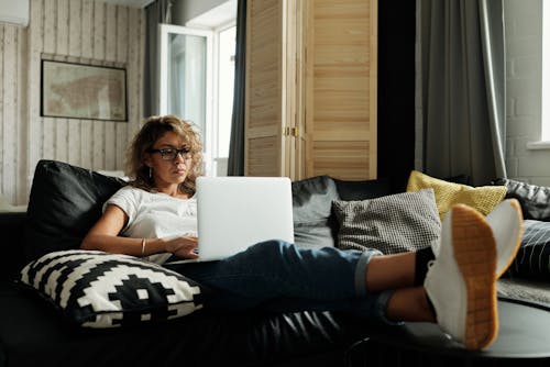 Free Photo Of Woman Sitting On A Couch Stock Photo