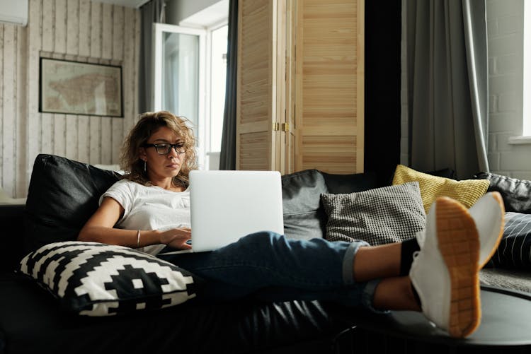 Photo Of Woman Sitting On A Couch