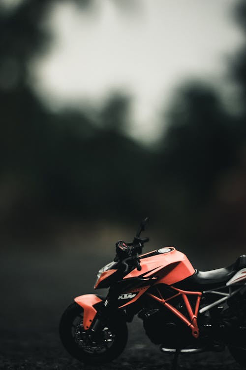 Miniature of motorbike on road against trees