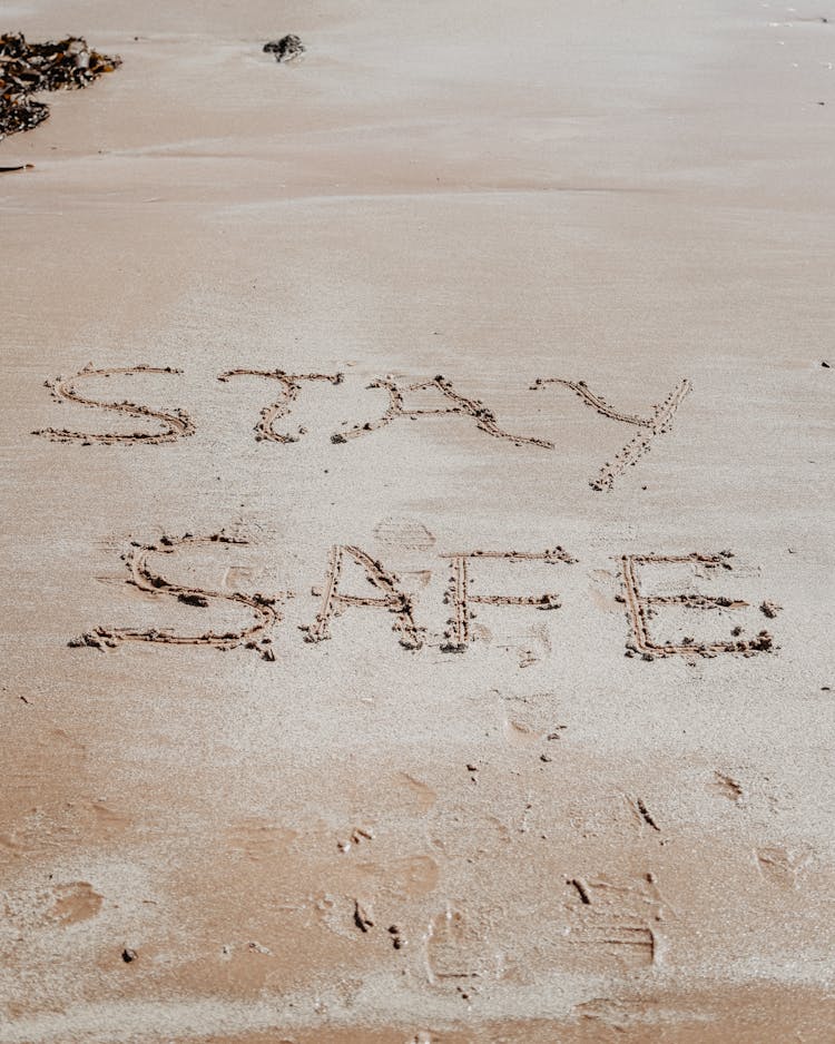 Stay Safe Text On Beach Sand