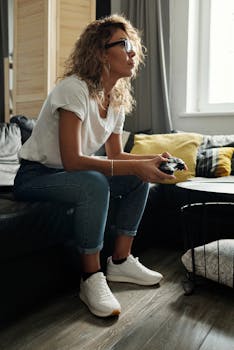 A woman enjoying a video game session at home on a cozy couch, focused and relaxed.