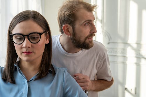 Man in White Crew Neck T-shirt Beside Woman in Blue Crew Neck T-shirt