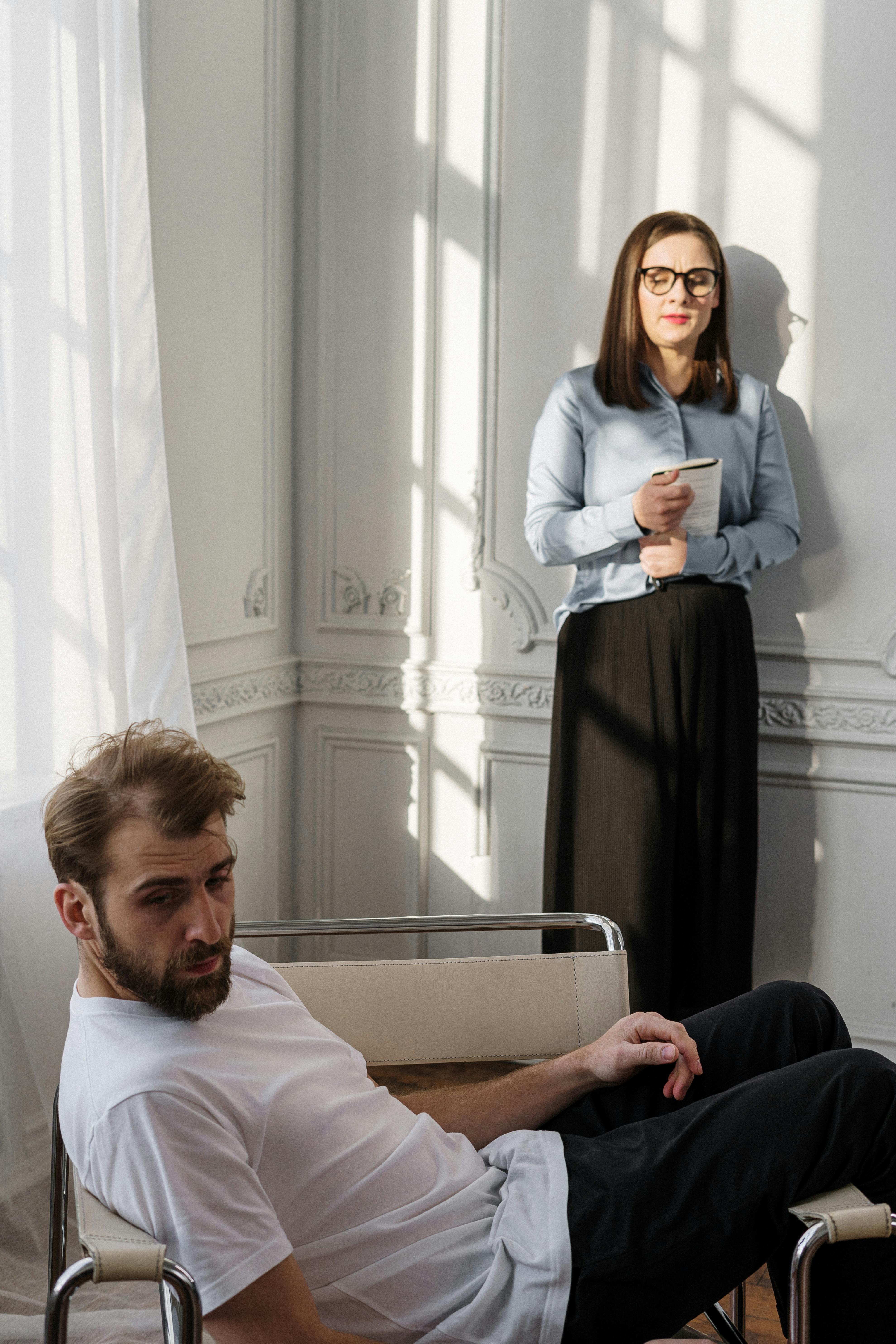 man in white dress shirt sitting beside woman in black dress