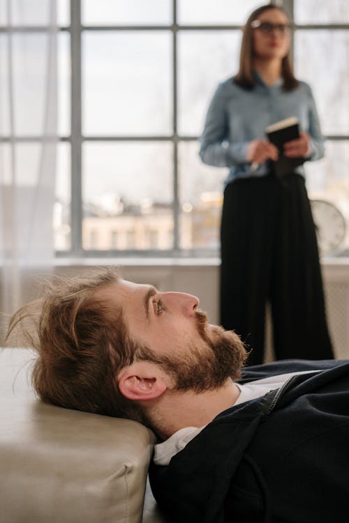 Man in Black Shirt Lying on Floor