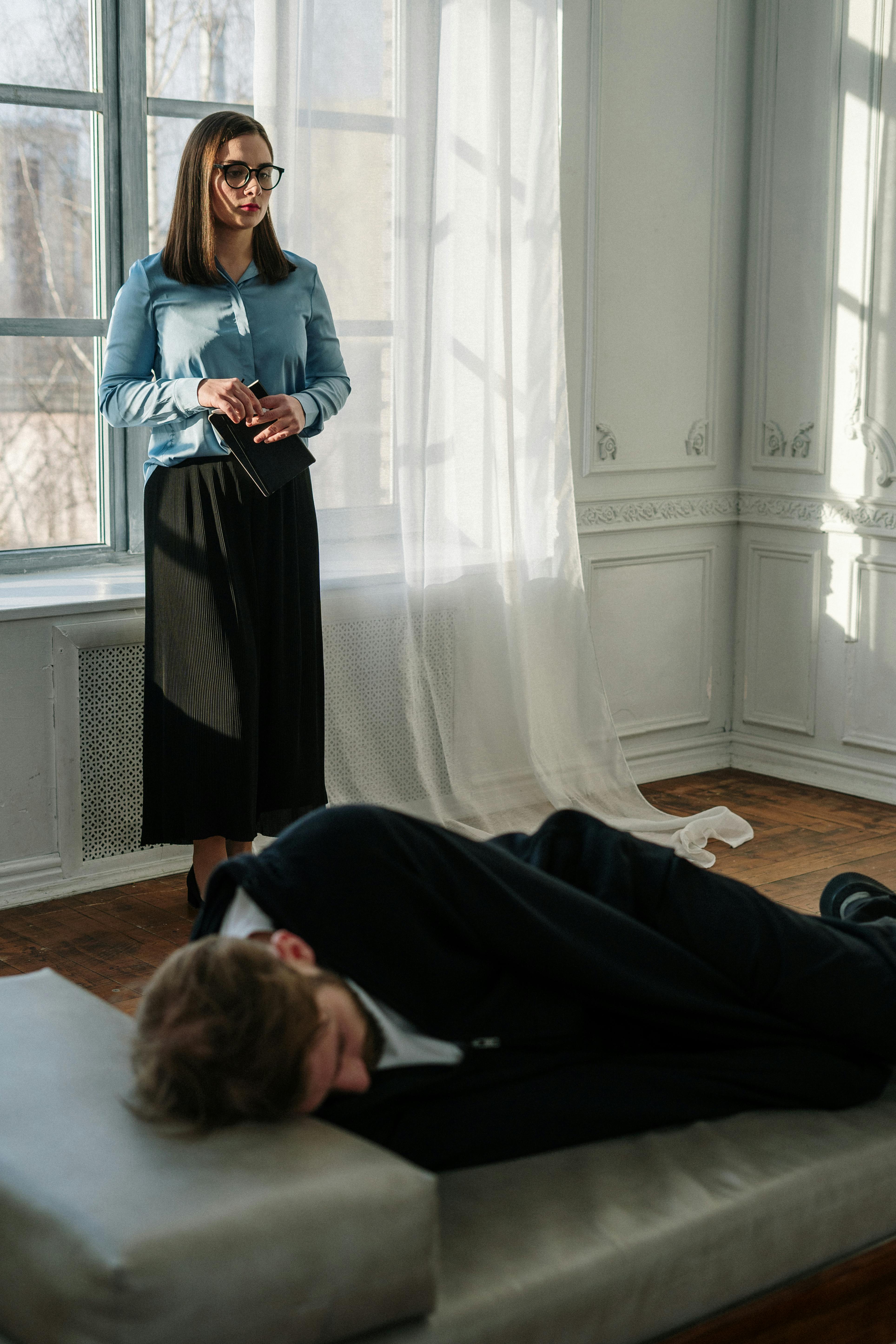 woman in blue long sleeve shirt sitting on floor