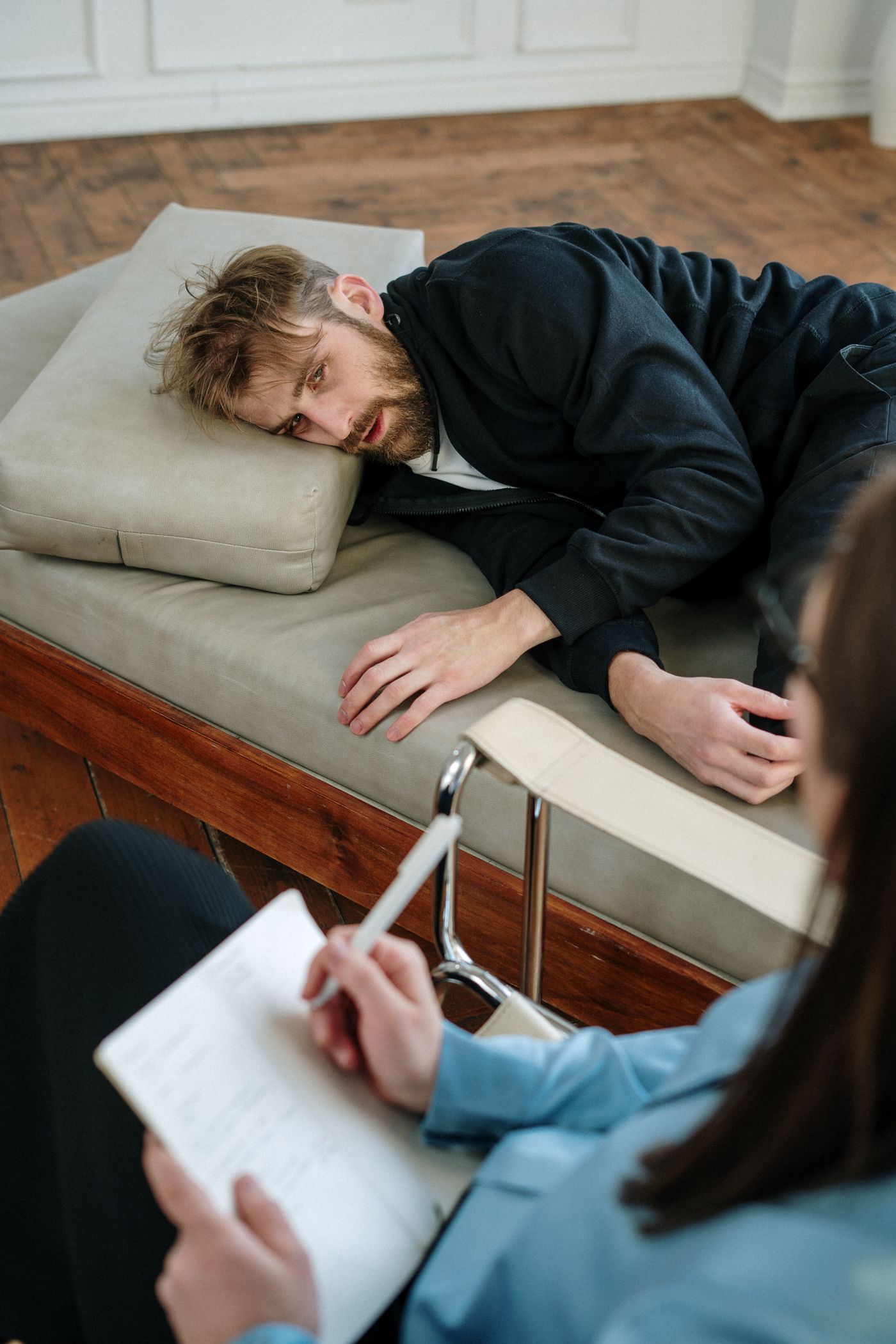 Mental health professional listening to an adult patient during a depression-focused counseling session