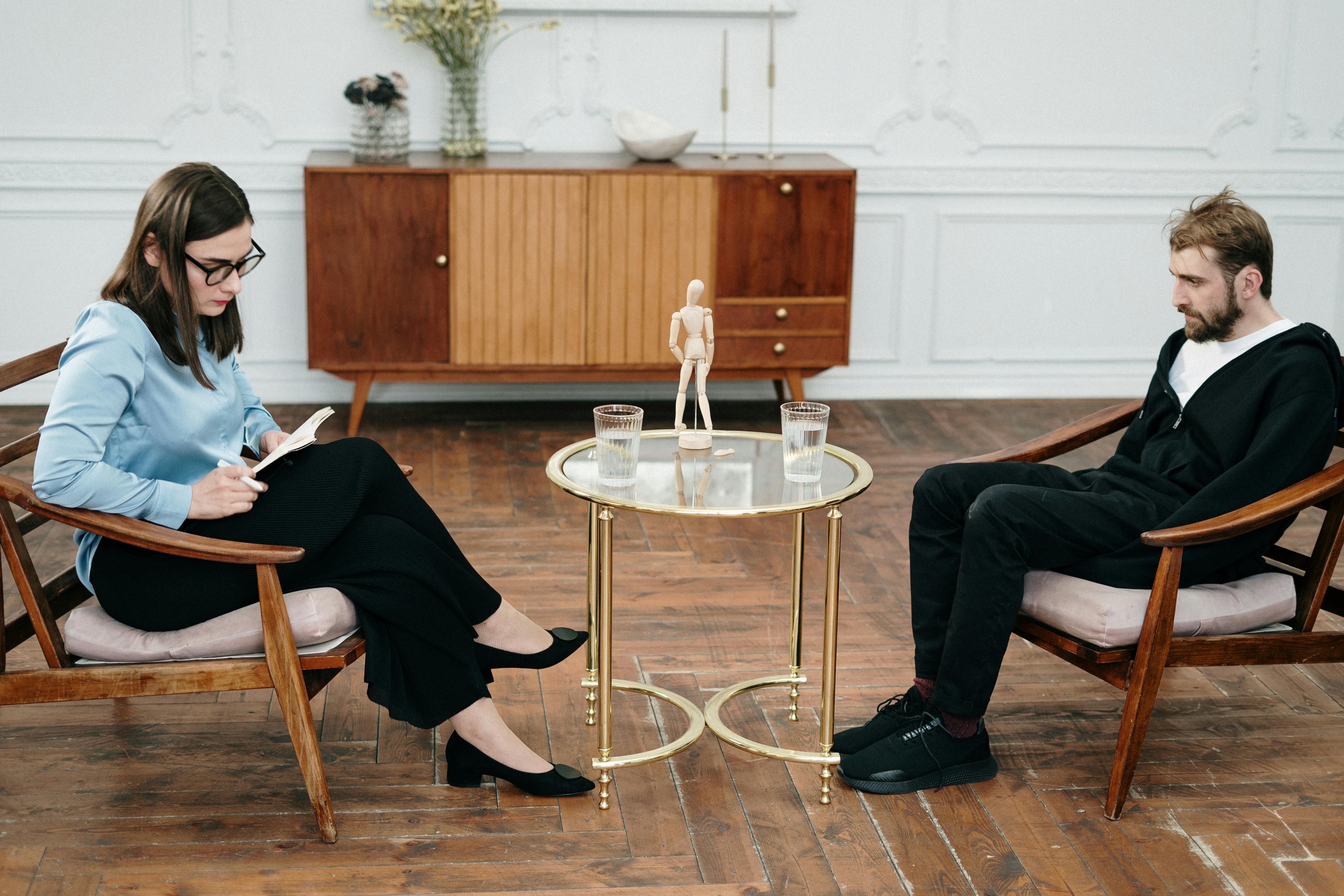 woman in black pants sitting on chair