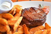 Roasted meat and fried potato on plate