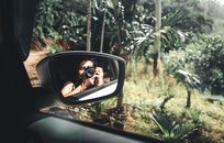 Person Taking Photo of Car Side Mirror