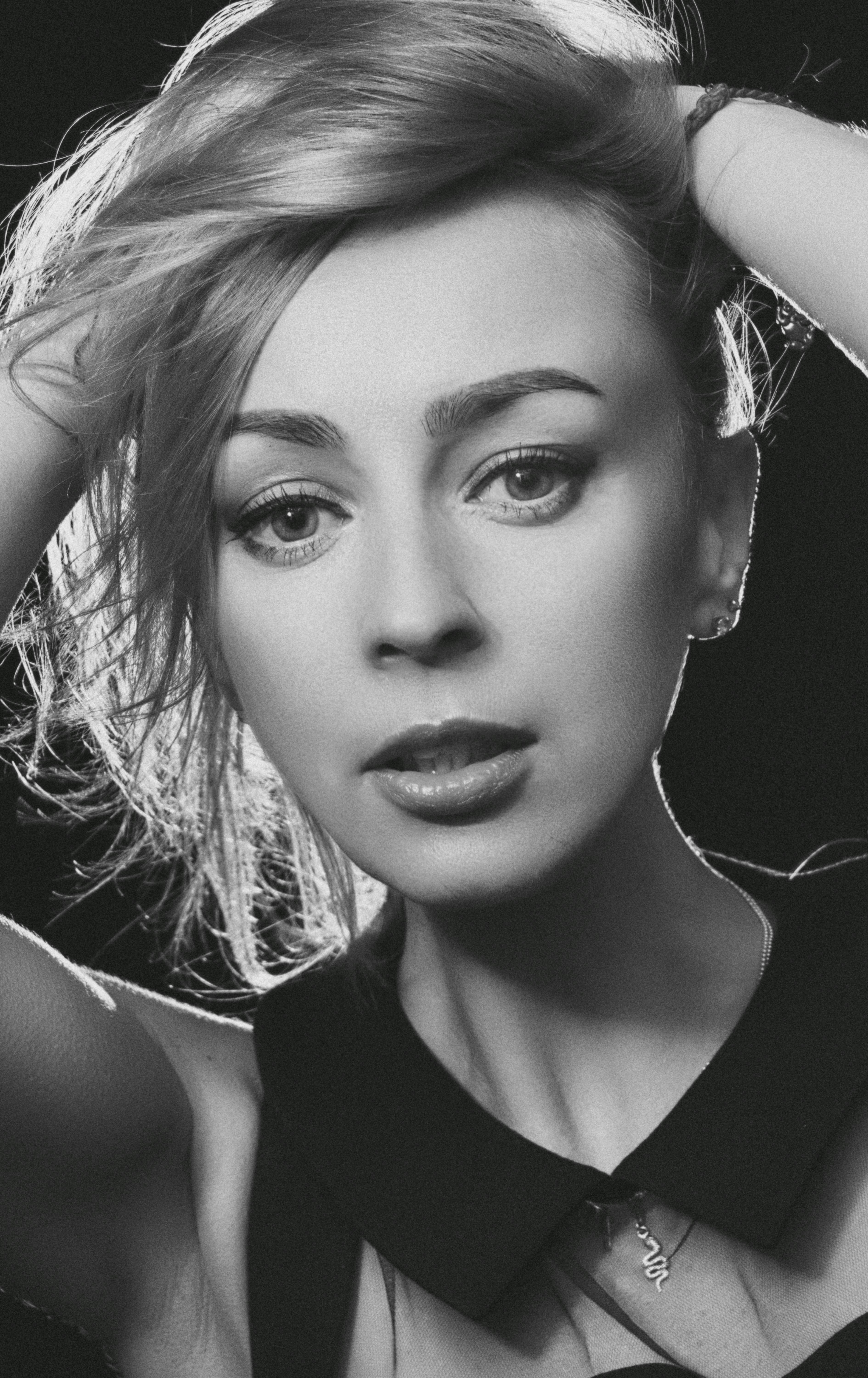 Striking black and white close-up portrait of a woman embracing elegance.