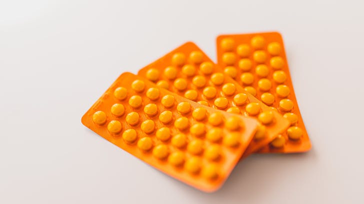 Orange packages of medications on table