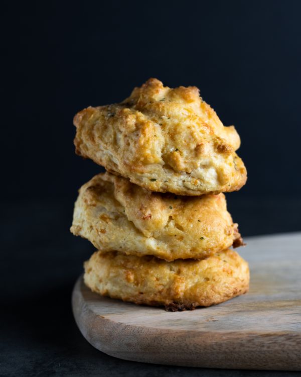 Freshly baked biscuits stacked on a wooden board — photo by Anna Pyshniuk on Pexels