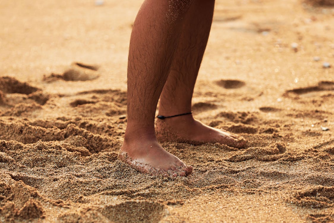Free Person Standing Barefooted On Sand Stock Photo