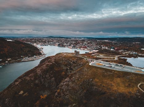 A dramatic aerial view of St. John's showcasing historic terrain and ocean vistas.