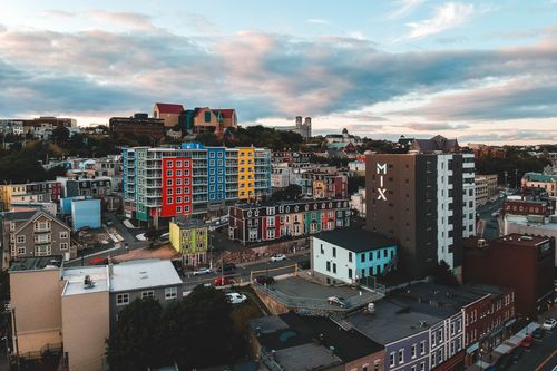 Free Drone view of modern style colorful multistage residential building facades under blue sky with clouds in city in daylight Stock Photo
