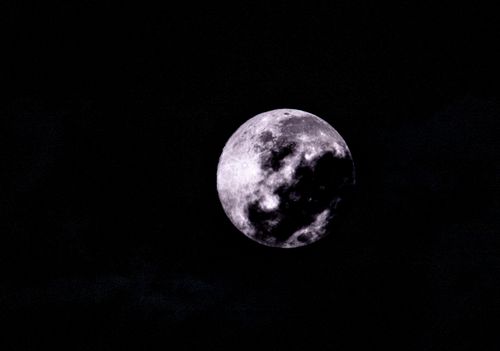 Free Atmospheric photo of the full moon shining in a dark sky, offering celestial charm. Stock Photo