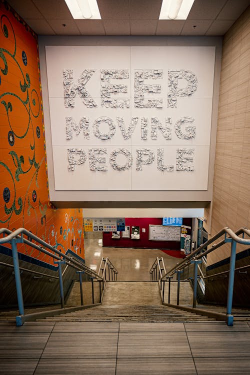 Staircase with Keep moving people inscription in shopping center