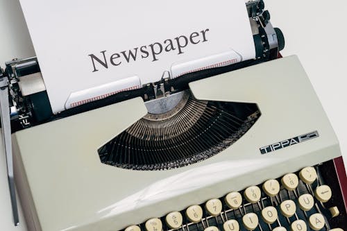 White Vintage Typewriter With Text On Paper