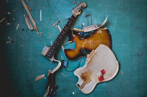Free Brown Broken Guitar on the Floor Stock Photo