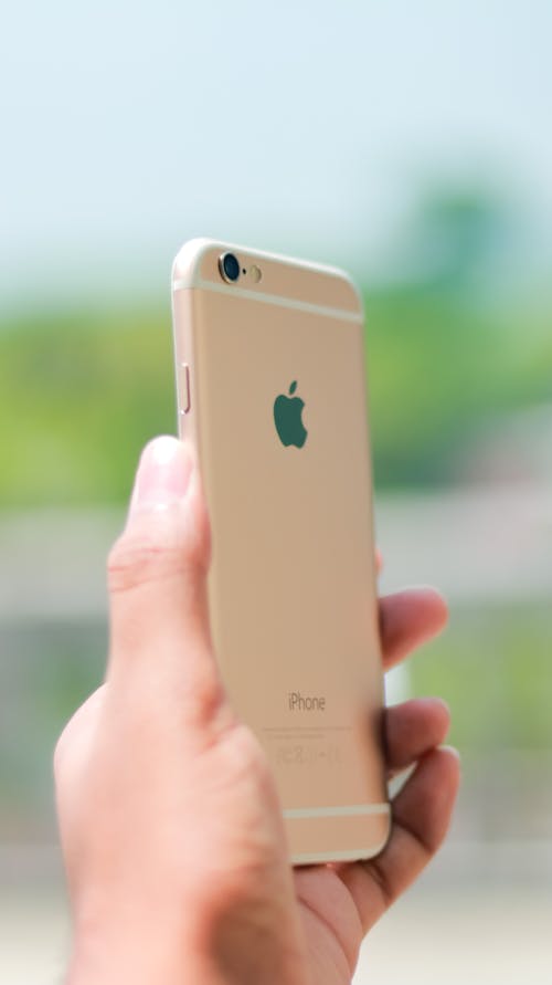Free Gold Iphone on Person's Hand Stock Photo