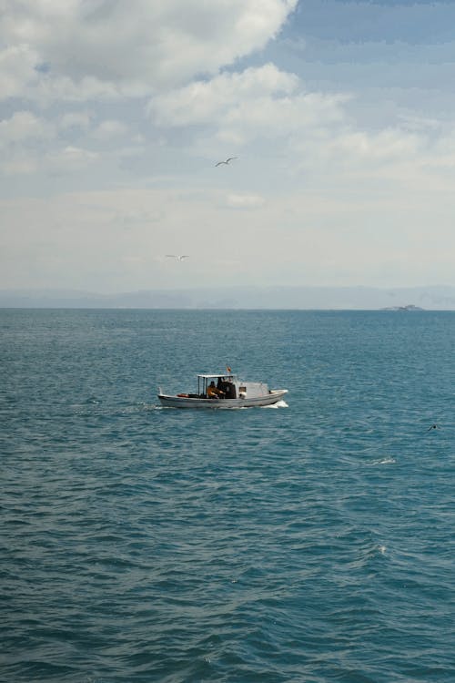Small motorboat cruising on rippling sea