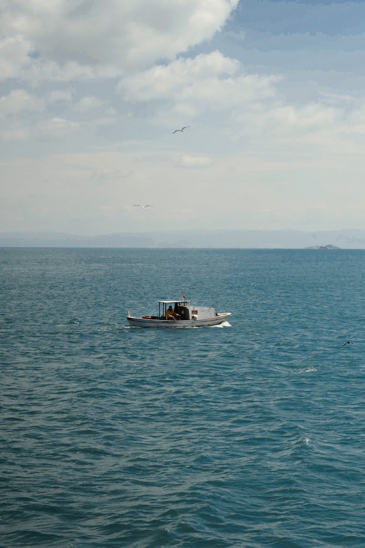 Small Motorboat Cruising On Rippling Sea