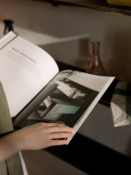 Person Reading an opened Magazine