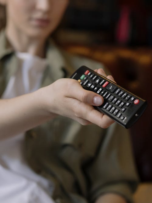 Person Holding Black Remote Control