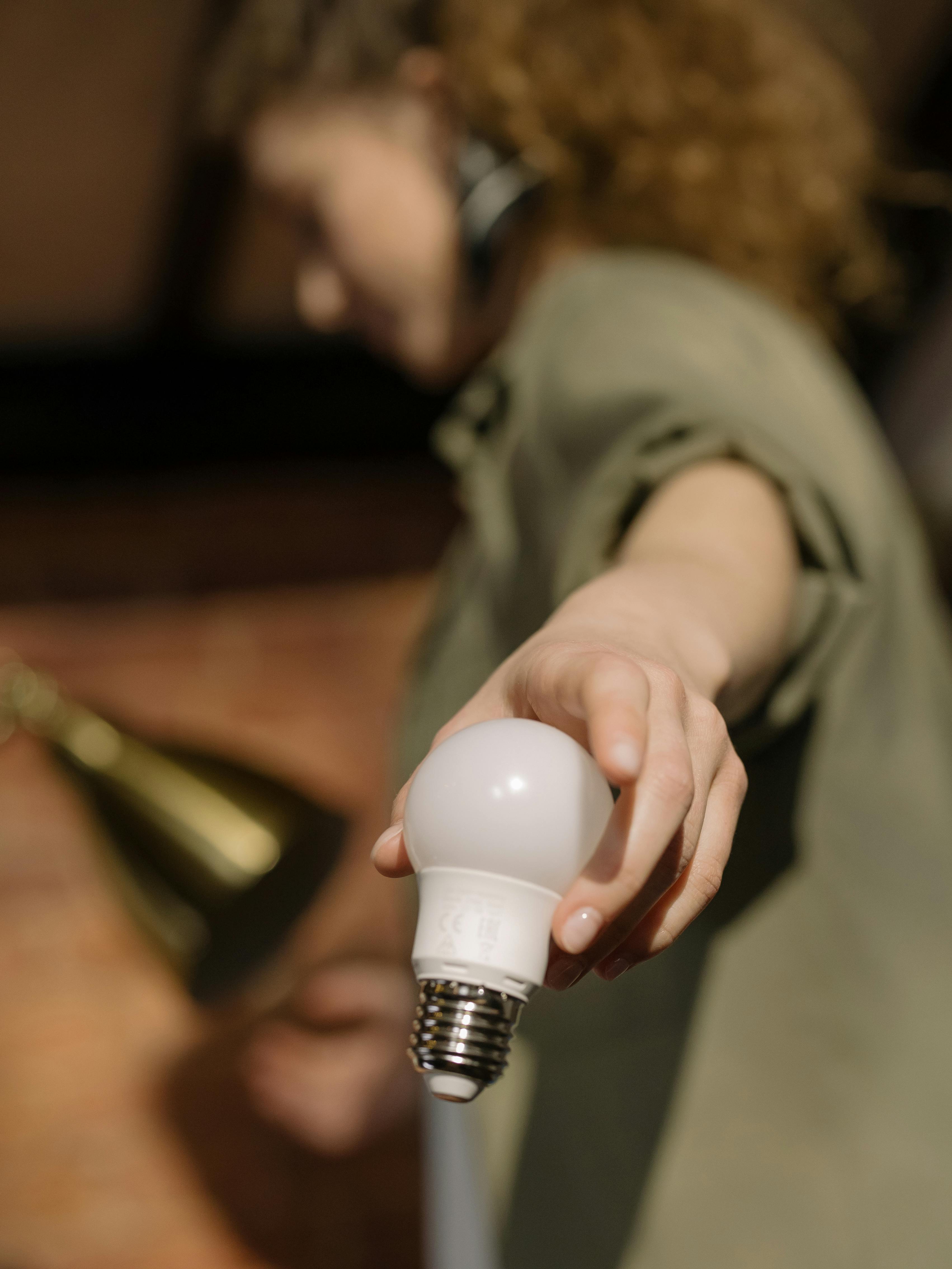 person holding white light bulb