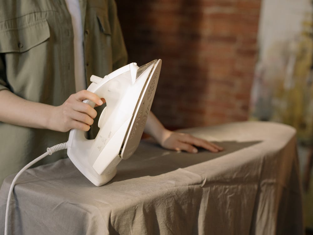 Free Person in Gray Dress Shirt Holding White Book Stock Photo