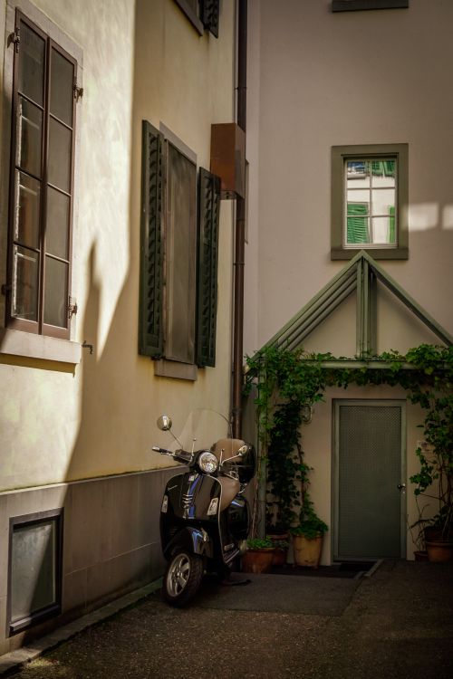Free Modern bike parked on backyard of cozy apartment building with white walls on sunny day Stock Photo