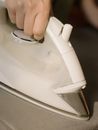 Person Holding White Clothes Iron