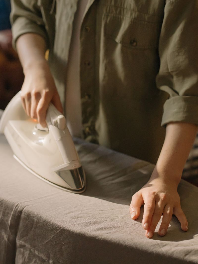 Close-up of hands treating fabric with care