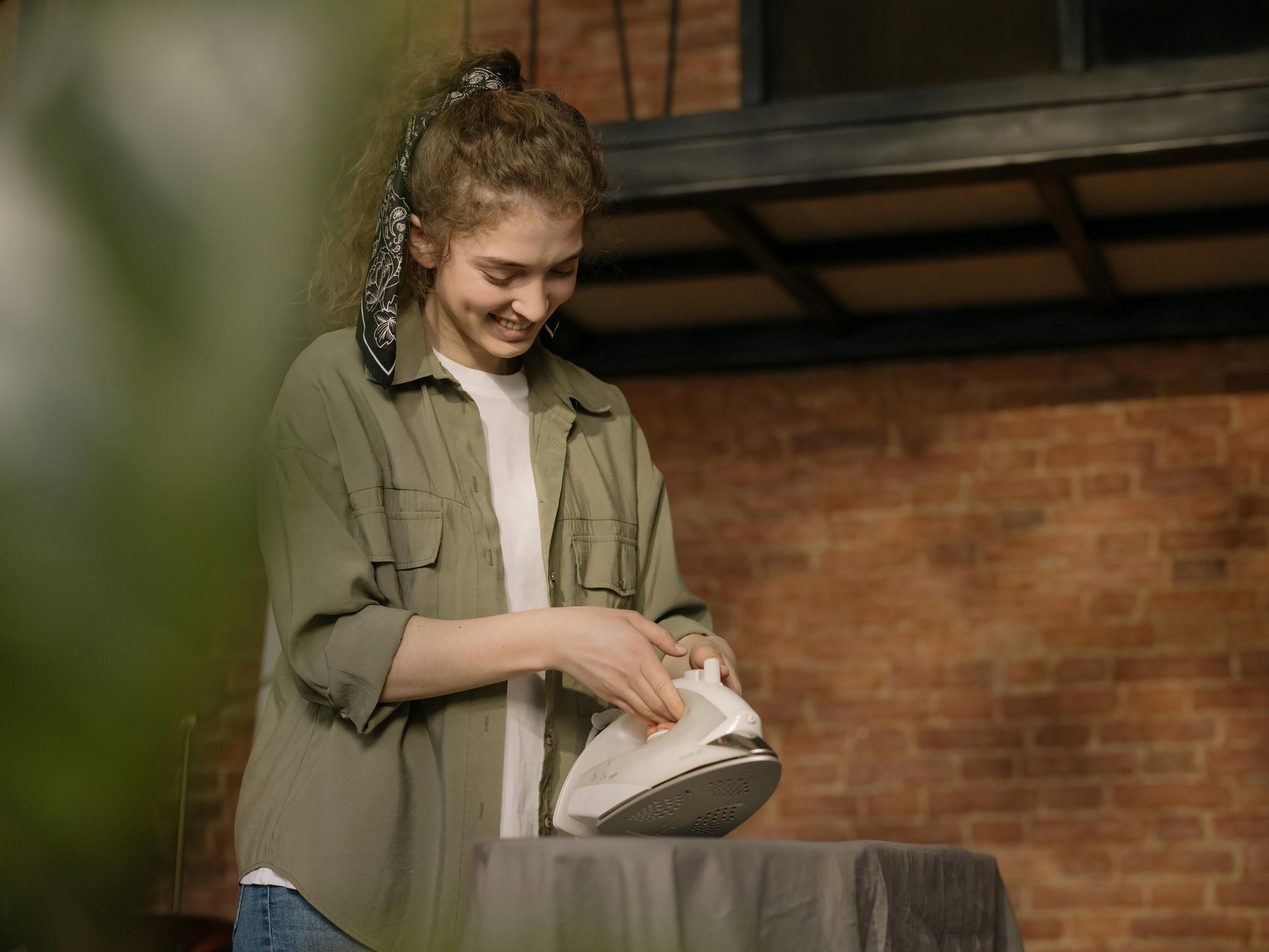 woman in green coat holding white and black nike sneakers