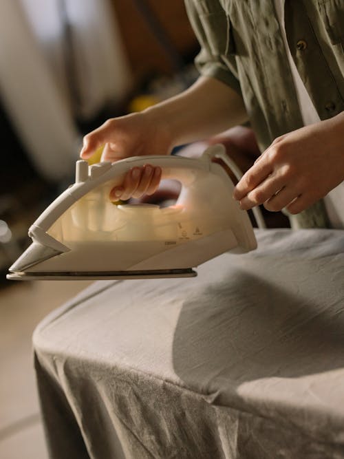 Person Holding White Clothes Iron