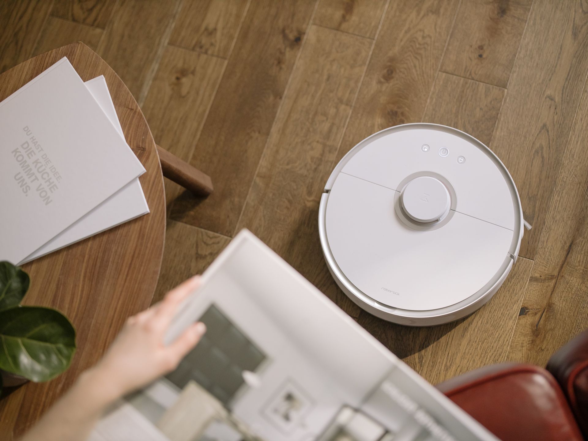 Person Holding White Round Device