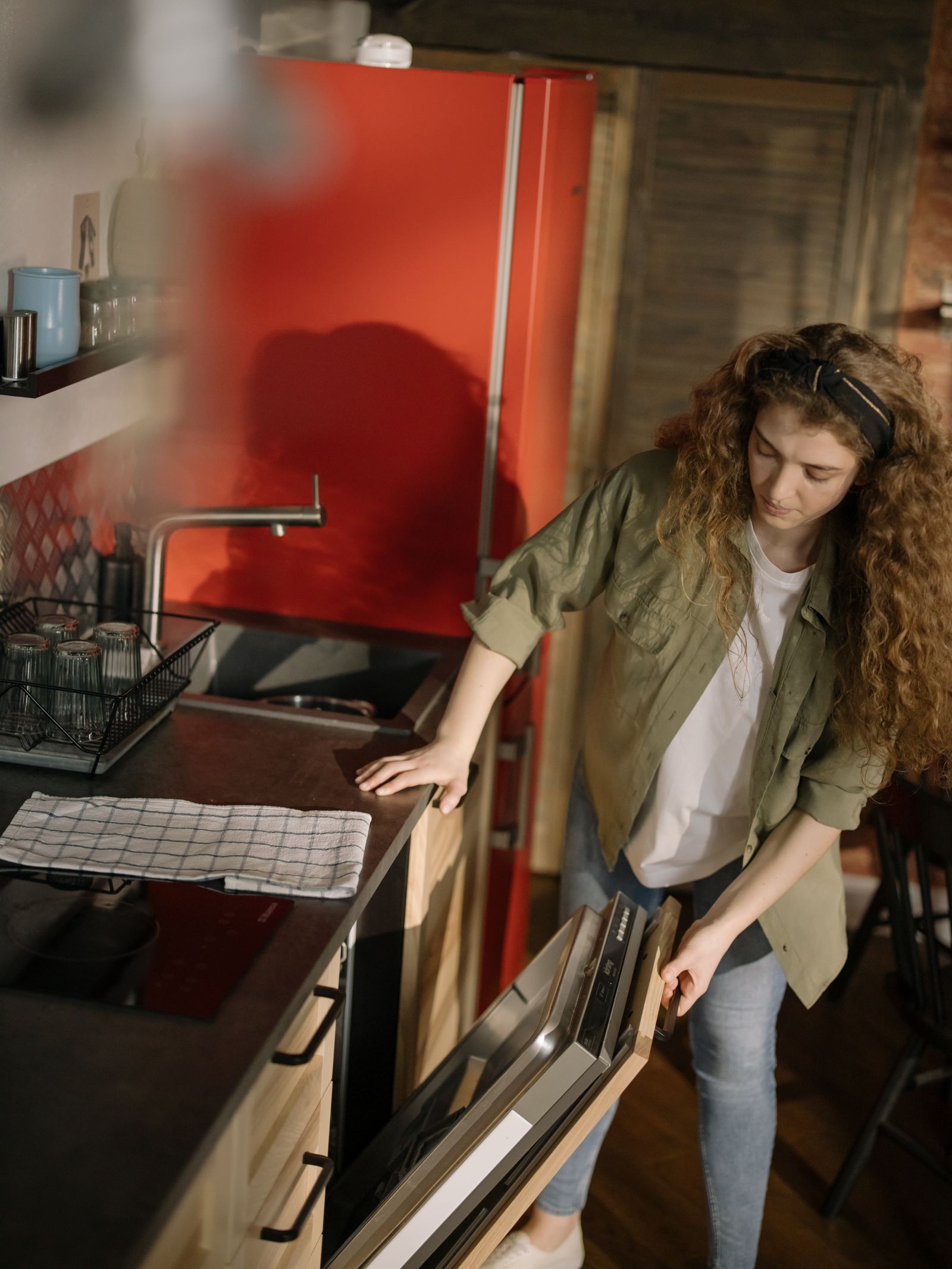 Open dishwasher appliance in modern kitchen for dishwasher diagnosis in The Meadows Dubai