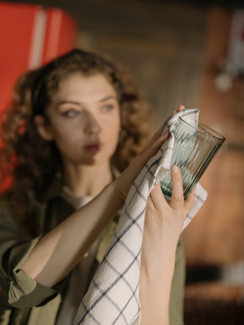 Woman in Black Tank Top Holding Clear Drinking Glass