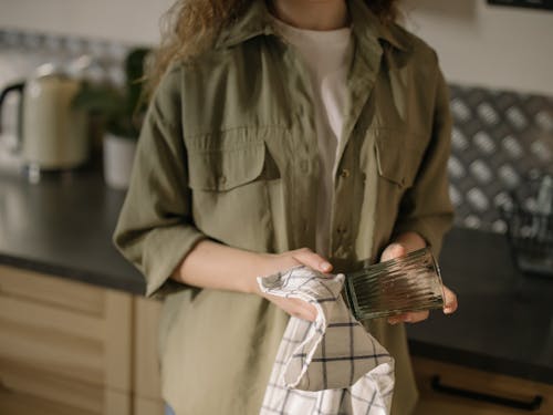 Woman in Green Button Up Shirt Holding Clear Glass Cup