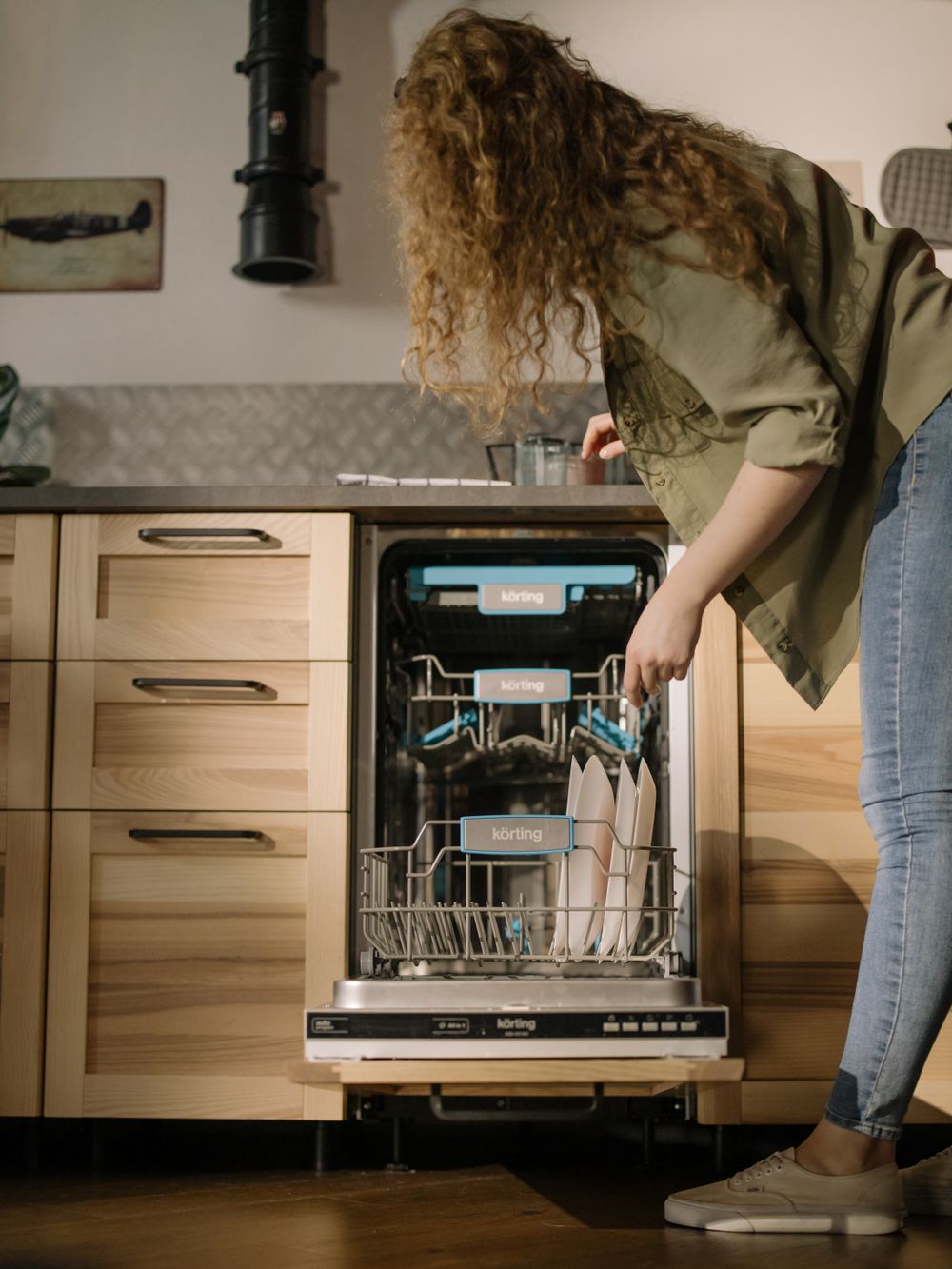 Woman loading a dishwasher