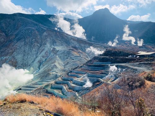 Free Smoking volcanic valley with fumaroles near majestic rough mountains in Hakone Japan Stock Photo